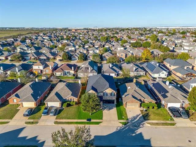 an aerial view of residential houses with outdoor space