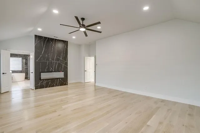 a bathroom with a bathtub a double vanity sink and a mirror