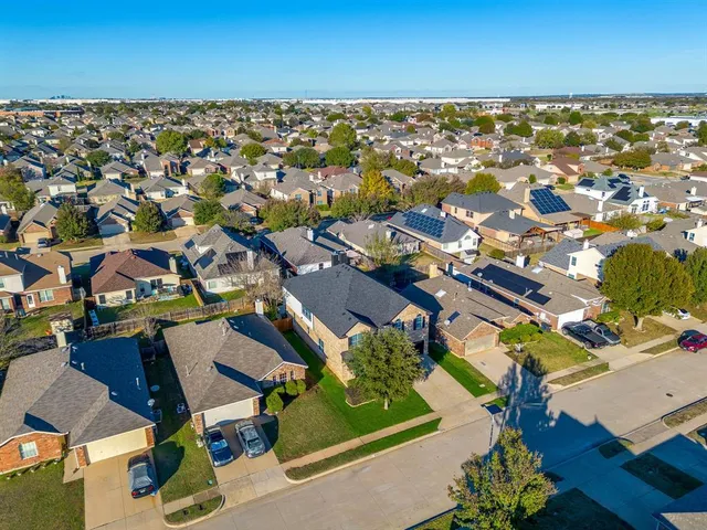 an aerial view of a building with outdoor space and ocean view