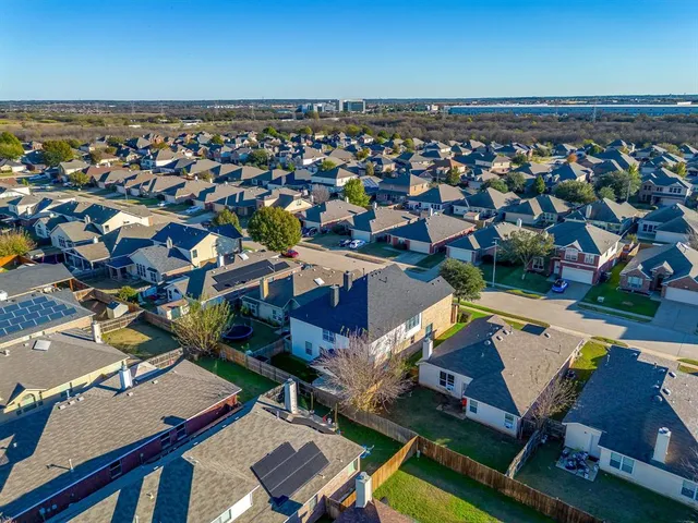 an aerial view of residential houses with outdoor space