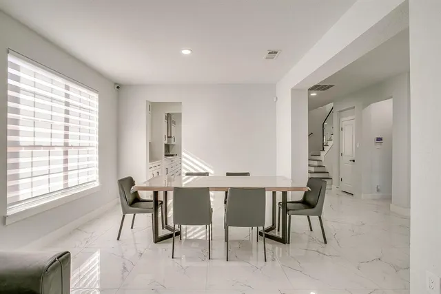 a view of a dining room with furniture and a window