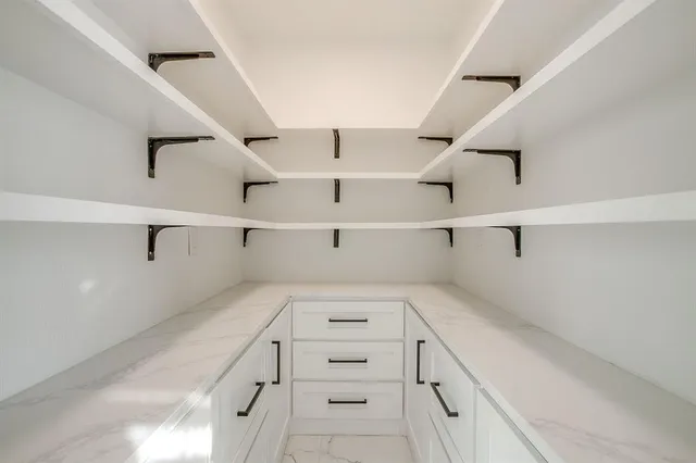 a kitchen with appliances a sink and cabinets