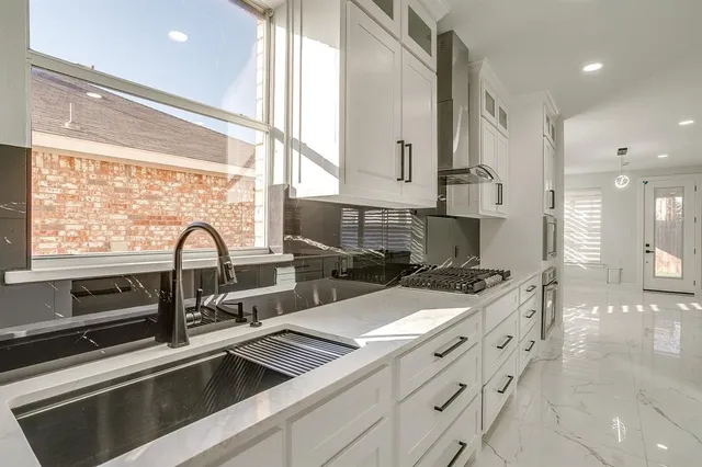 a kitchen with counter top space and sink