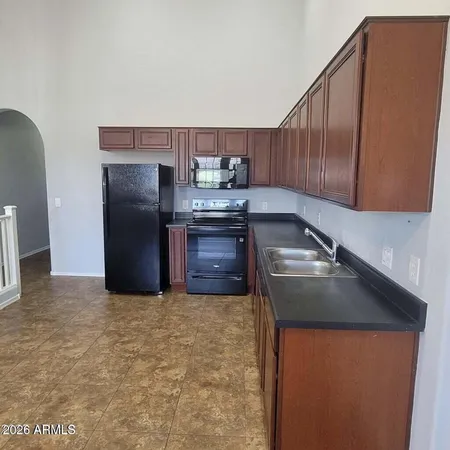 a kitchen with a sink and a refrigerator