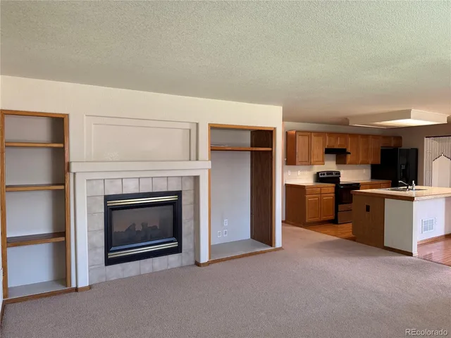 a view of a kitchen with a sink cabinets and a fireplace