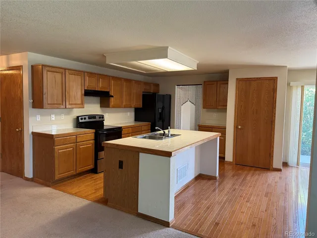 a kitchen with stainless steel appliances granite countertop a stove and a refrigerator