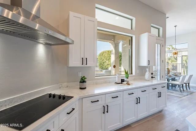 a kitchen with appliances a sink and cabinets