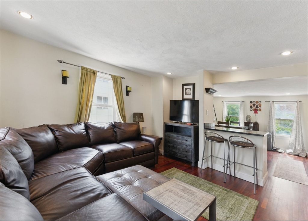 40 Chappie Street, Unit 1 Boston, MA 02129 - Photo 1 of 10 a living room with furniture and a flat screen tv