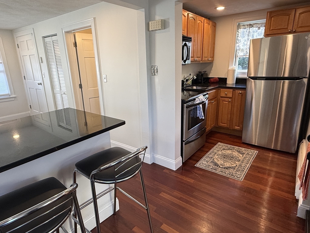 40 Chappie Street, Unit 1 Boston, MA 02129 - Photo 8 of 10 a kitchen with stainless steel appliances a refrigerator a stove a sink and a microwave