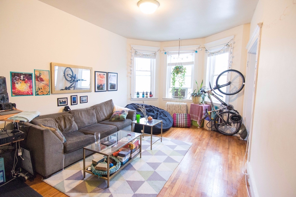 233 Kelton Street, Unit 1 Boston, MA 02134 - Photo 1 of 11 a living room with furniture and a large window