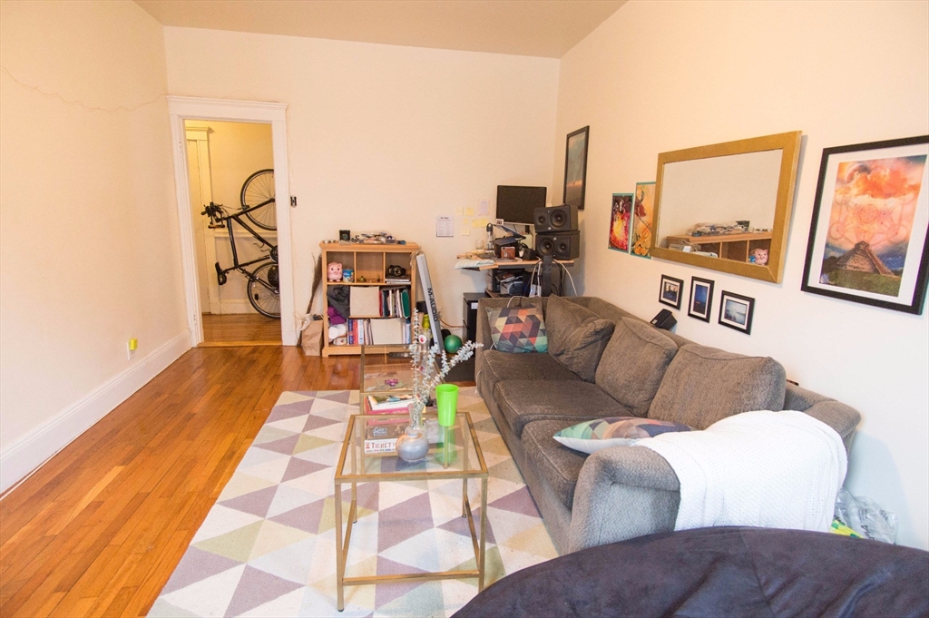233 Kelton Street, Unit 1 Boston, MA 02134 - Photo 3 of 11 a living room with furniture and floor to ceiling window