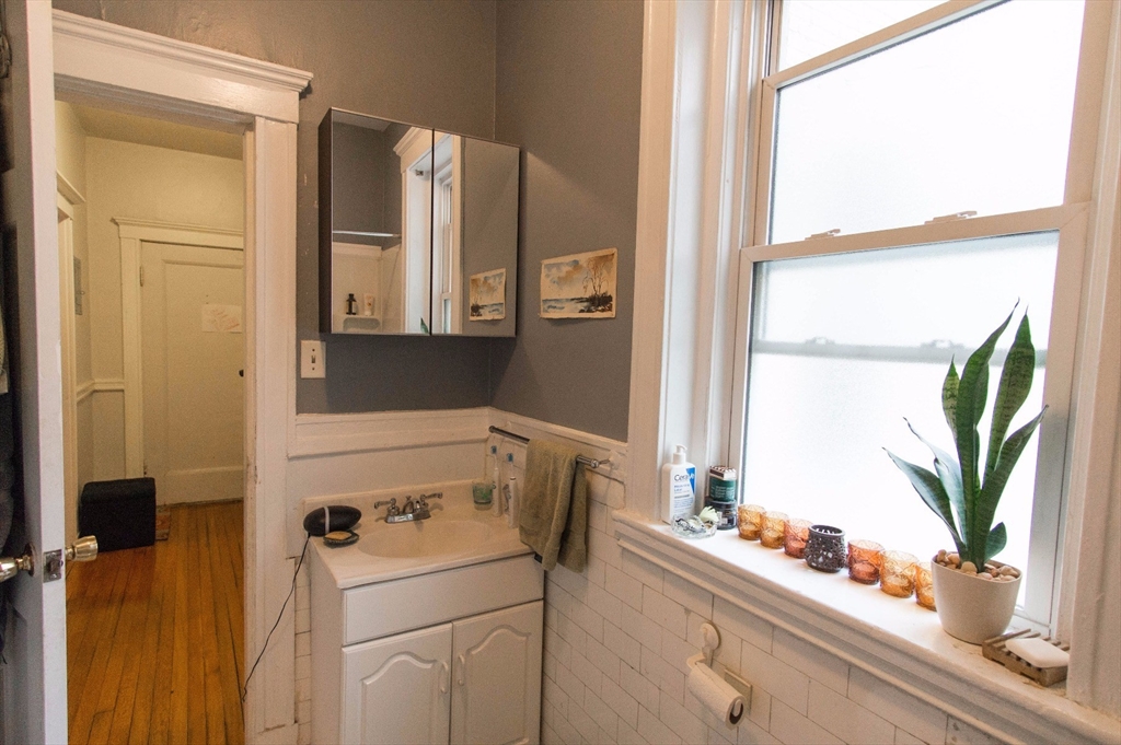 233 Kelton Street, Unit 1 Boston, MA 02134 - Photo 4 of 11 a bathroom with a sink and a mirror