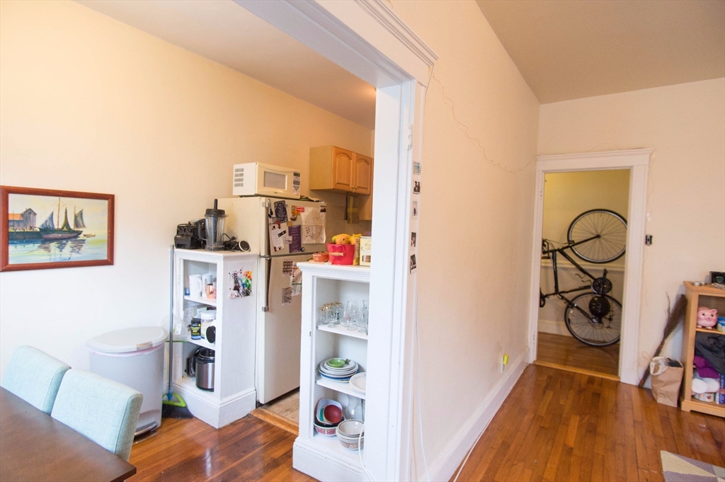 233 Kelton Street, Unit 1 Boston, MA 02134 - Photo 9 of 11 a view of a bedroom with workspace and a living room