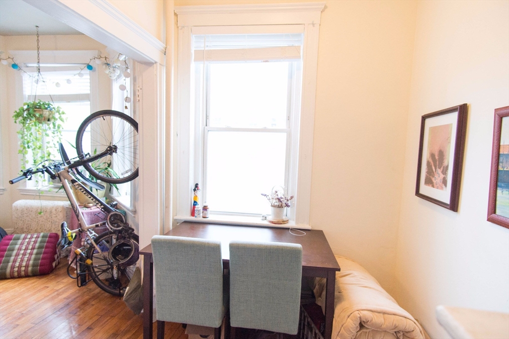 233 Kelton Street, Unit 1 Boston, MA 02134 - Photo 10 of 11 a dining room with furniture and a window