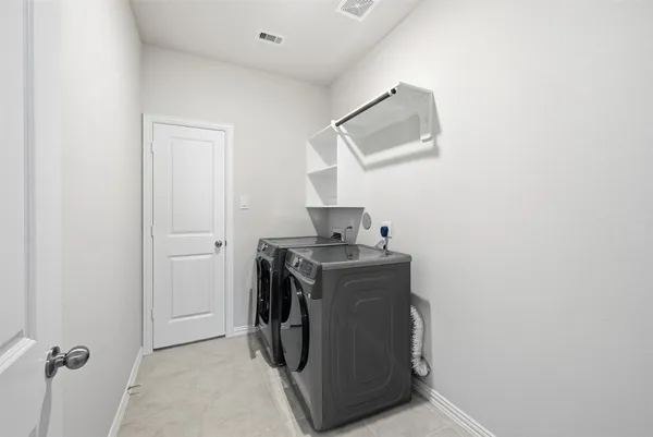 a utility room with a sink dryer and washer