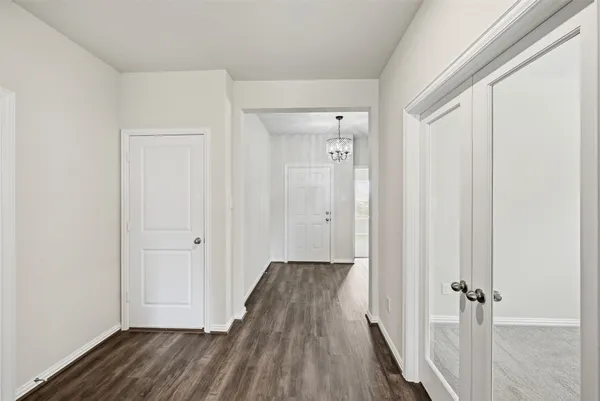a view of a hallway with wooden floor