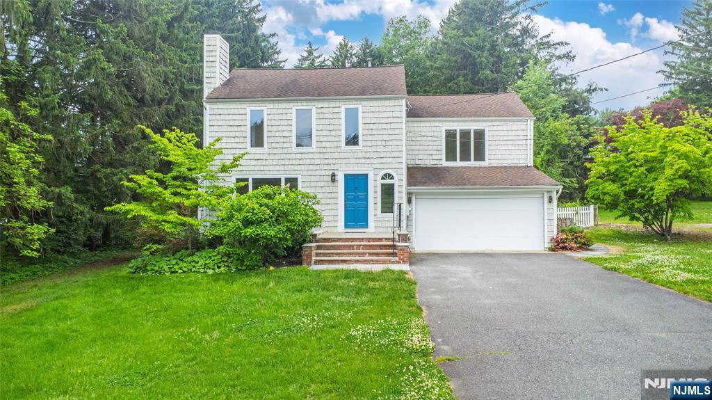 163 Sand Spring Road Morristown, NJ 07960 - Photo 1 of 39 a front view of a house with a garden and yard