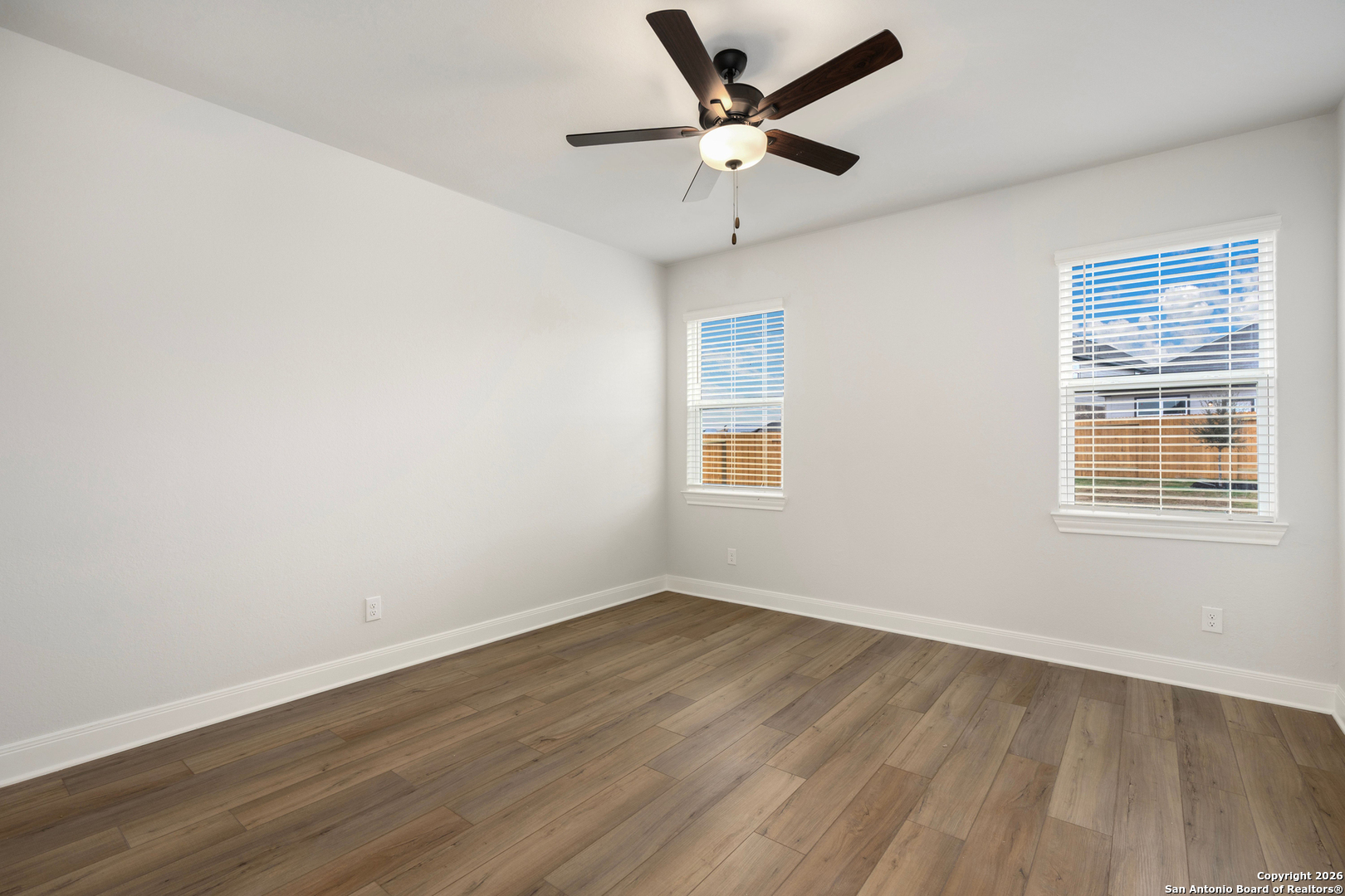 6311 Monk Landing Converse, TX 78109 - Photo 11 of 16 an empty room with wooden floor and windows