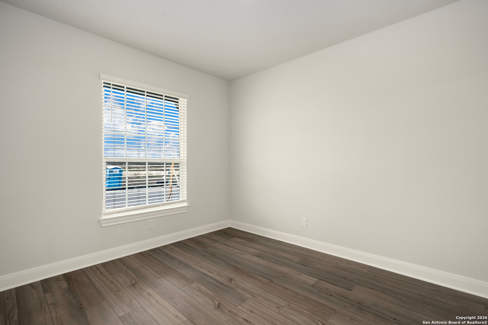 6311 Monk Landing Converse, TX 78109 - Photo 3 of 16 a view of an empty room with wooden floor and a window