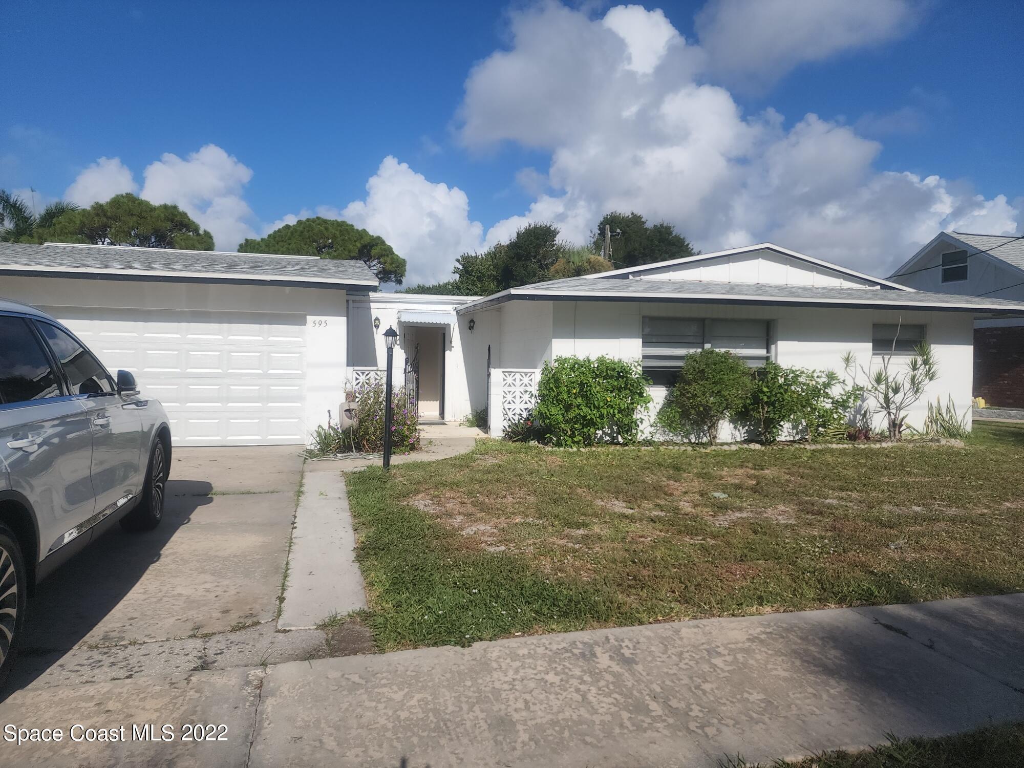595 Albatross Street Merritt Island, FL 32952 - Photo 1 of 21 a front view of a house with garden