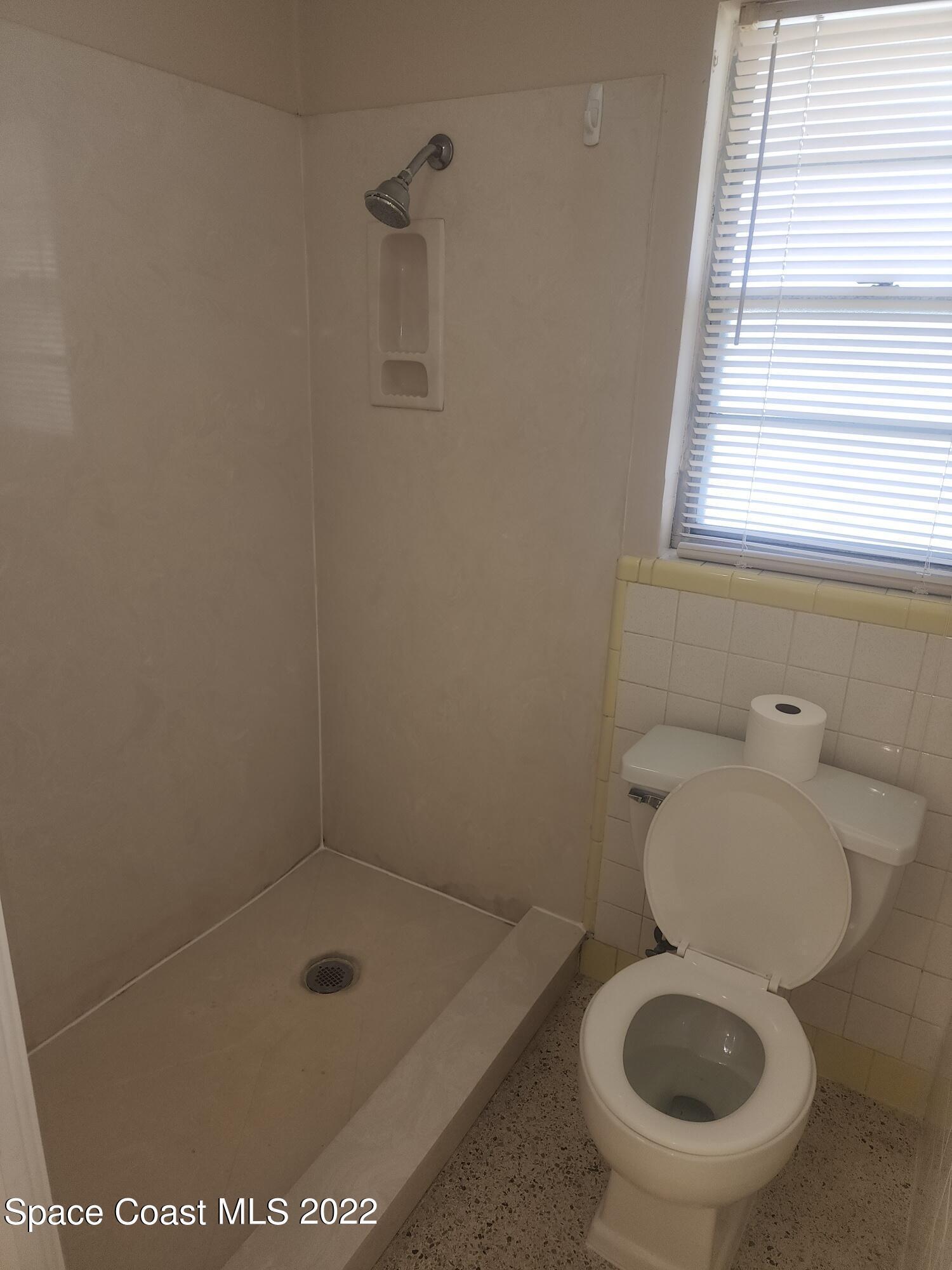 595 Albatross Street Merritt Island, FL 32952 - Photo 17 of 21 a bathroom with a sink and a toilet