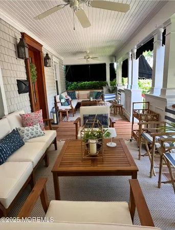 a view of a patio with couches table and chairs and potted plants