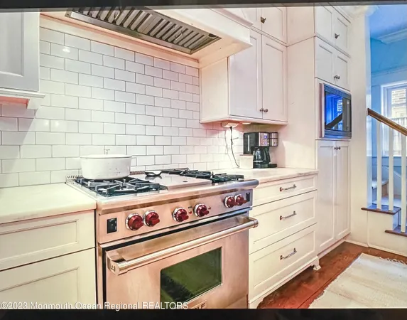 a living room with furniture a rug and a large window