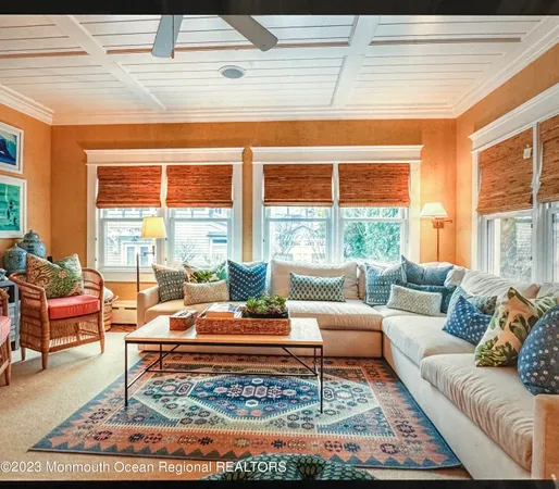 a dining room with furniture a chandelier and wooden floor