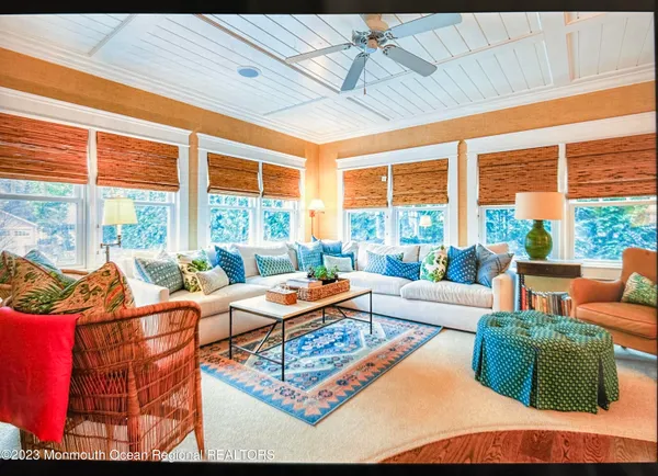 a dining room with furniture a chandelier and wooden floor