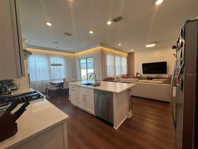 a kitchen with counter top space appliances and windows