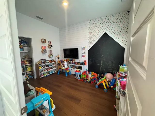a room with furniture and a flat screen tv
