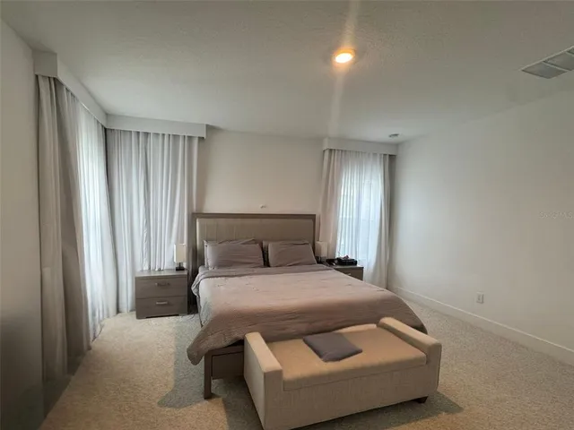 walk in closet with clothes and shoes