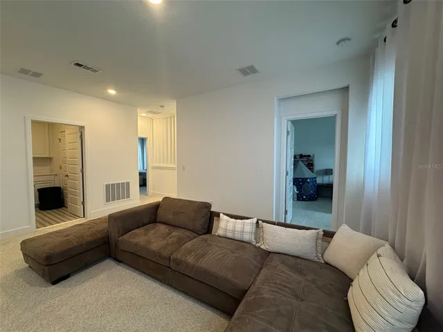 a bedroom with furniture and a night stand