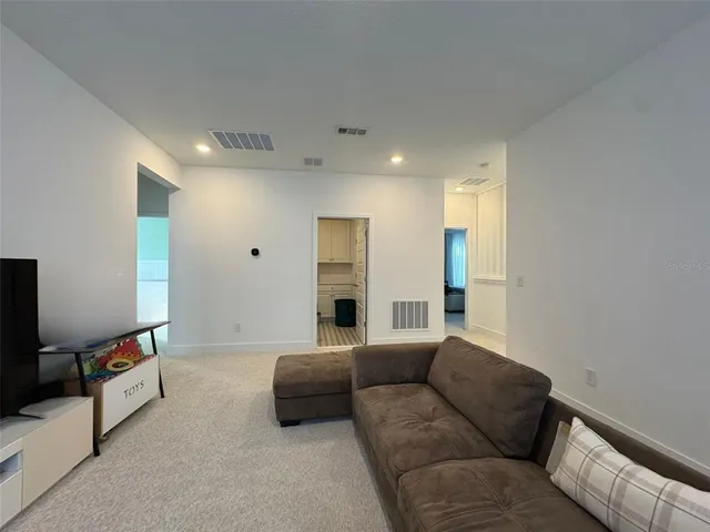 a bedroom with a bed and a couch