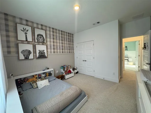 a bathroom with a sink a toilet a mirror and shower curtain