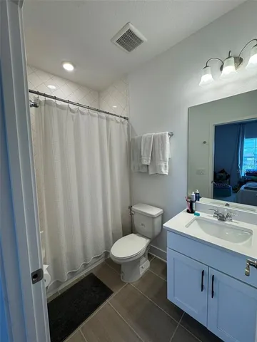 a view of a house with a big yard and a fountain