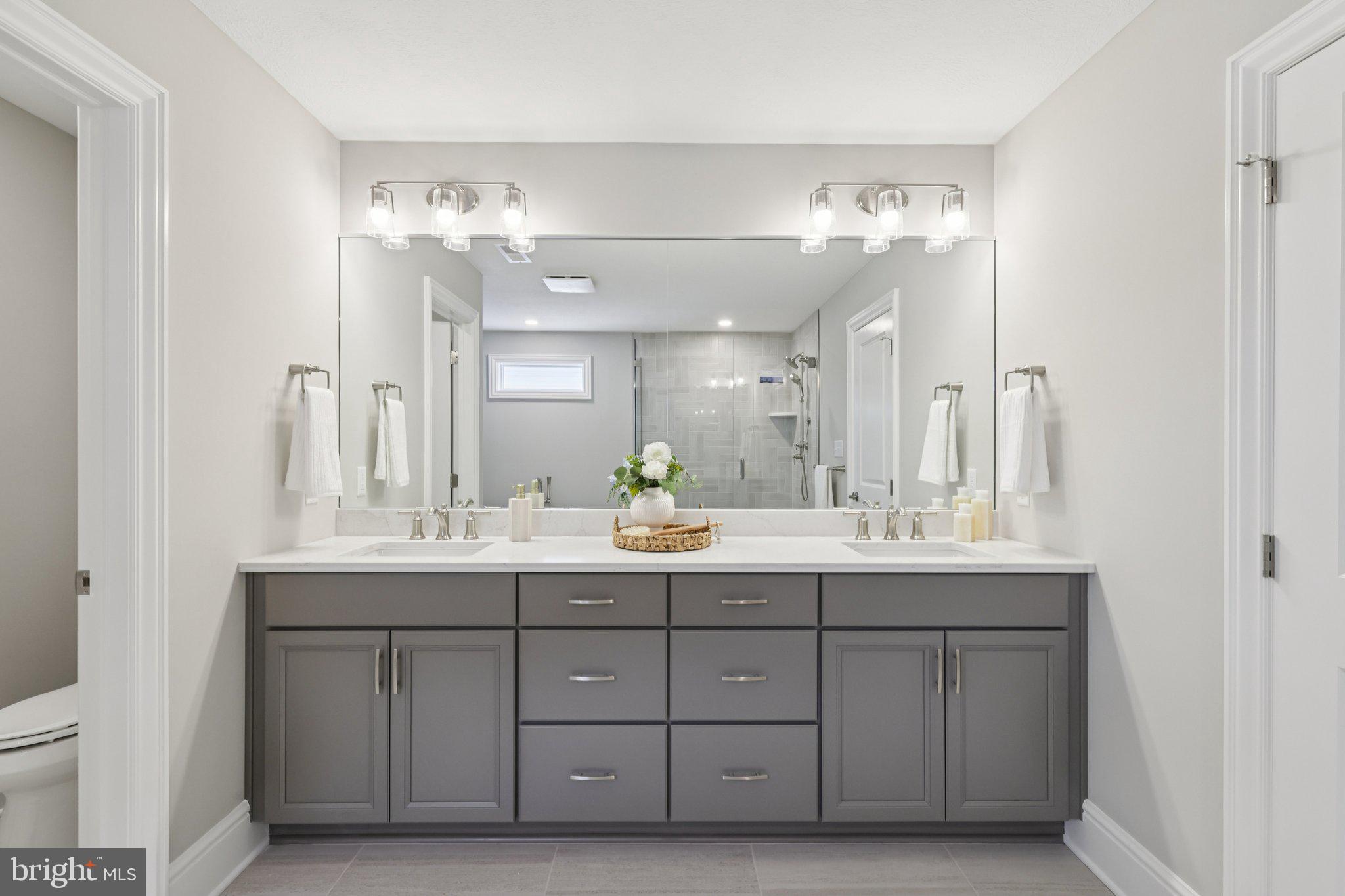510 Newcomen Road, Unit F1P Exton, PA 19341 - Photo 29 of 56 a bathroom with a double vanity sink and a mirror