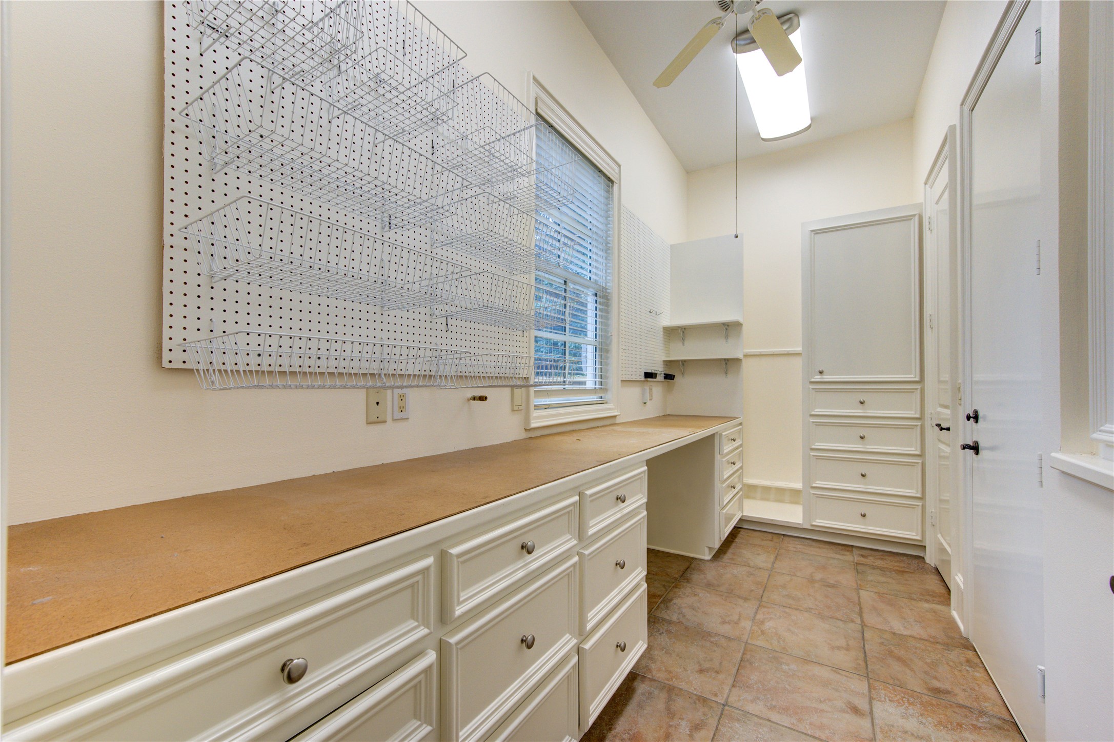 4615 Laurel Street Bellaire, TX 77401 - Photo 23 of 48 Custom workshop with "air compressor line" , work bench, gun rack, & cabinets for storage.