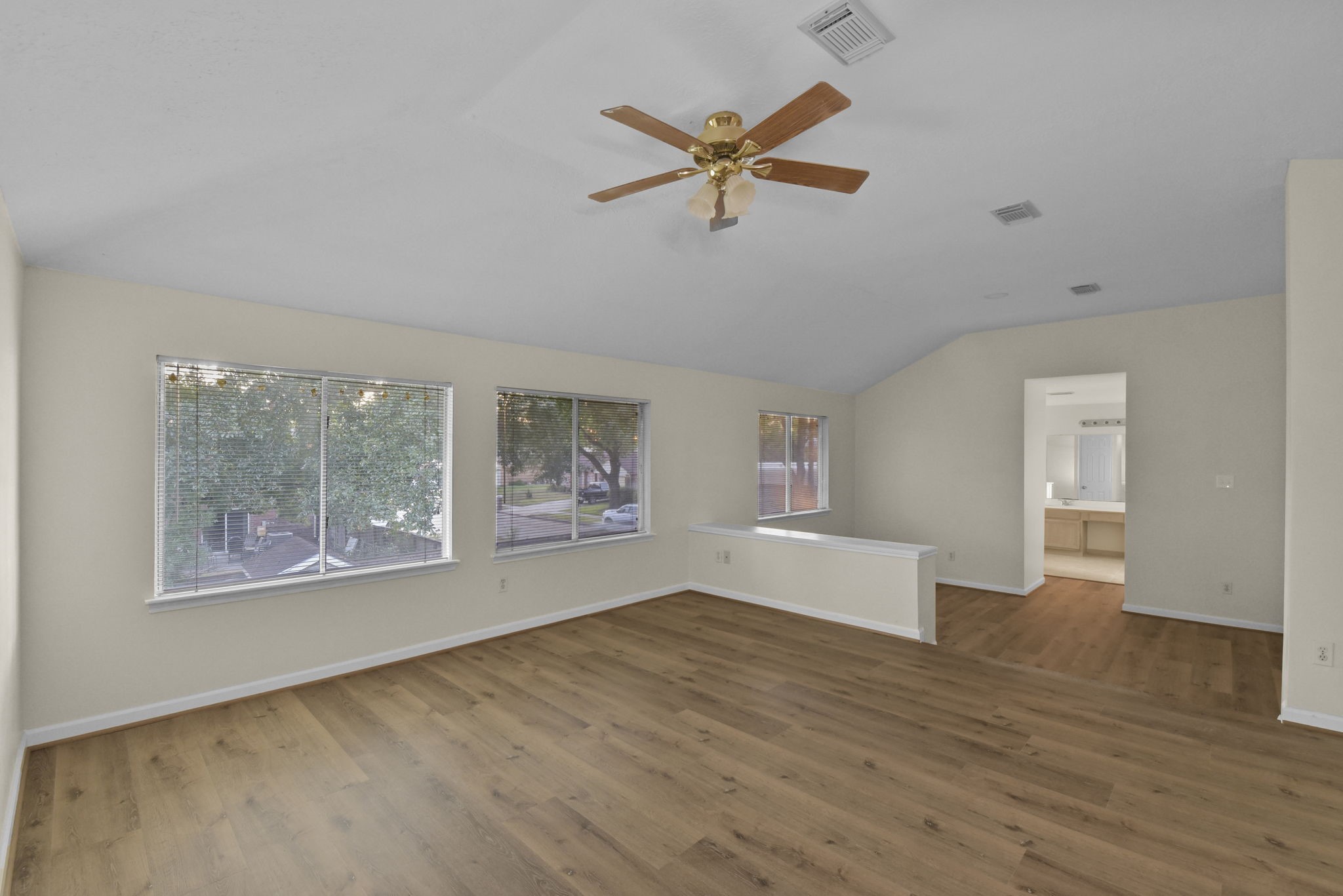 4911 Silver Fox Drive Houston, TX 77066 - Photo 19 of 33 a view of empty room with wooden floor and fan