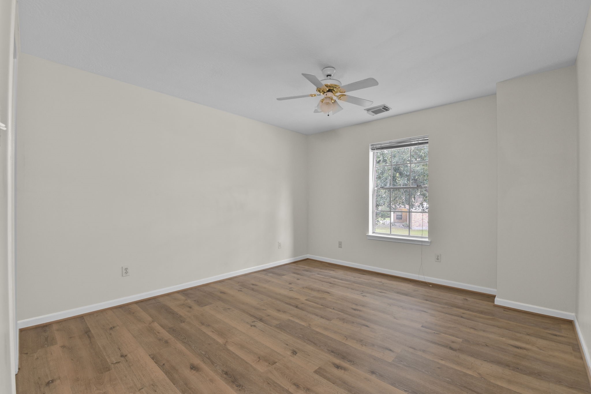 4911 Silver Fox Drive Houston, TX 77066 - Photo 27 of 33 a view of empty room with wooden floor and fan