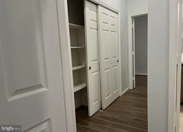 a view of a hallway with wooden floor