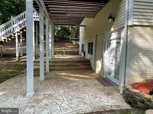 a view of a porch with wooden floor and stairs