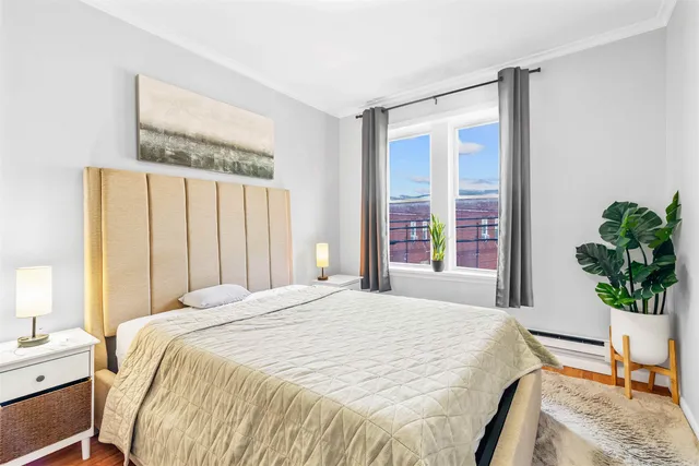 a bedroom with a large bed and a potted plant