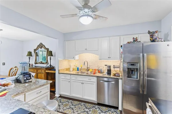 a kitchen with a sink stainless steel appliances and cabinets