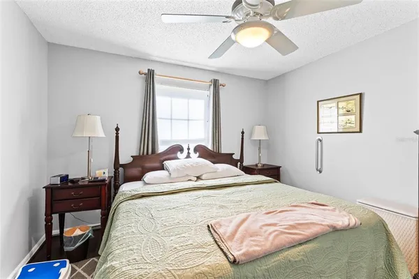 a bedroom with a bed and a chandelier