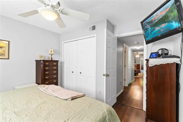 a bedroom with a bed and a flat screen tv