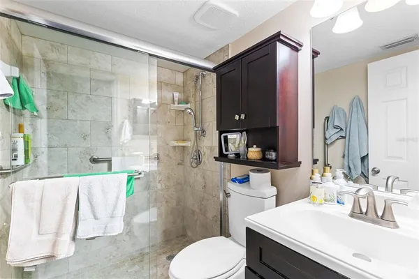 a bathroom with a sink vanity mirror and toilet