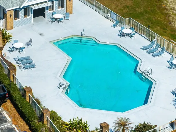 a view of a swimming pool with an outdoor seating