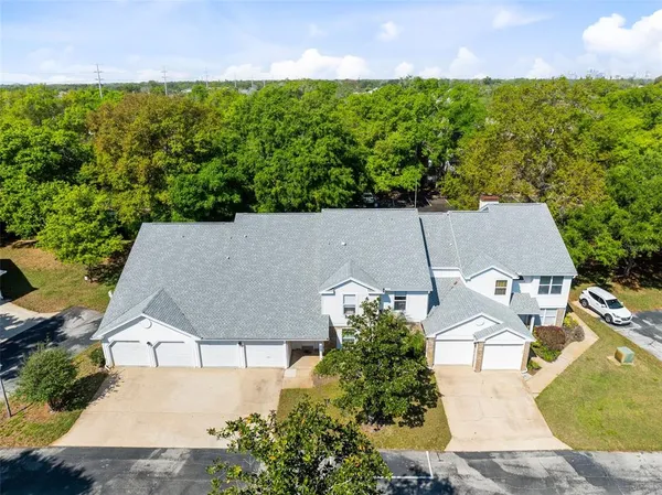an aerial view of a house with a yard and outdoor seating