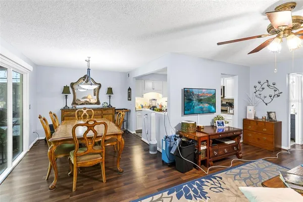 a living room with furniture a chandelier and a wooden floor
